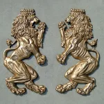 pair of wall mounted royal lion crest sculptures
