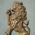 pair of wall mounted royal lion crest sculptures