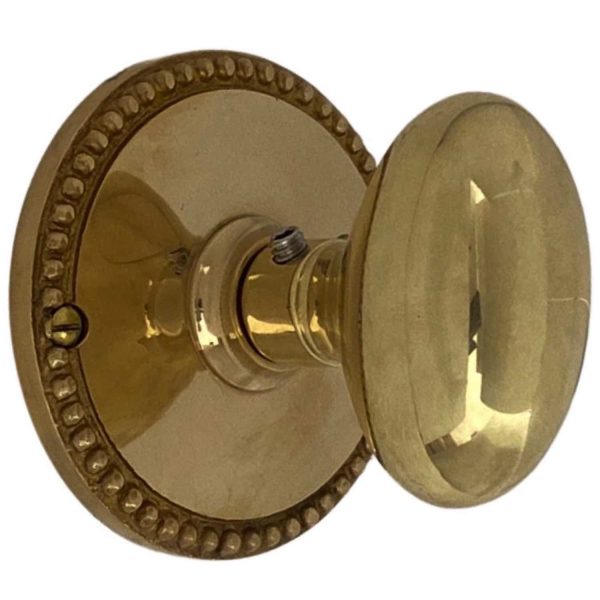 round beaded privacy set in polished brass with oval door knobs