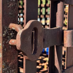 real antique rusted iron jail cell prison with fold up bed western holding cell