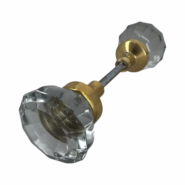 pair of clear glass door knobs with brass ferrules
