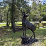 elk statue on rocks 10 foot bronze painted aluminum – left facing
