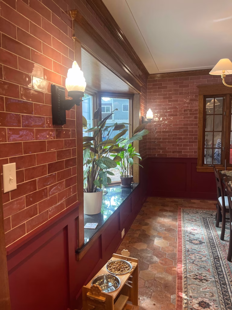 Customer Showcase Customer photo of antique style wall sconces from The Kings Bay lighting a red brick hallway