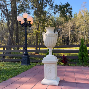 New Home 2026 English Queen Anne faux marble urn on pedestal in a garden, front view